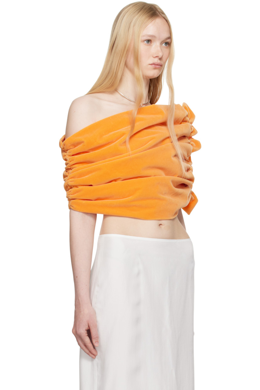Cotton velvet top.

· Asymmetrical off-the-shoulder construction
· Ruching at sides
· Ruffled trim at side
· Full poplin lining

Supplier color: Peach
