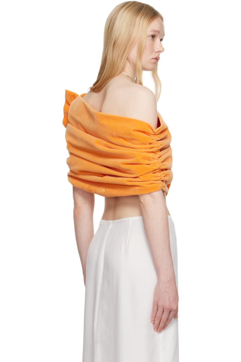 Cotton velvet top.

· Asymmetrical off-the-shoulder construction
· Ruching at sides
· Ruffled trim at side
· Full poplin lining

Supplier color: Peach