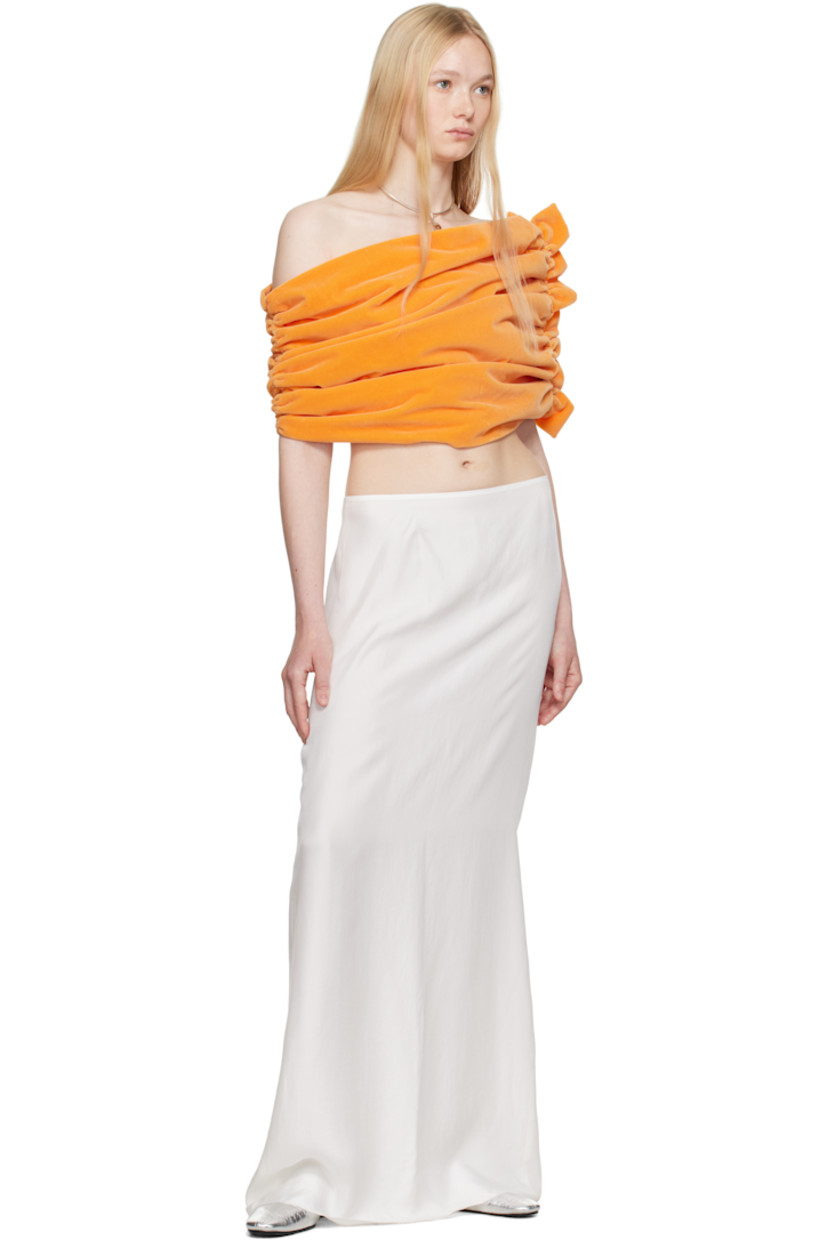 Cotton velvet top.

· Asymmetrical off-the-shoulder construction
· Ruching at sides
· Ruffled trim at side
· Full poplin lining

Supplier color: Peach