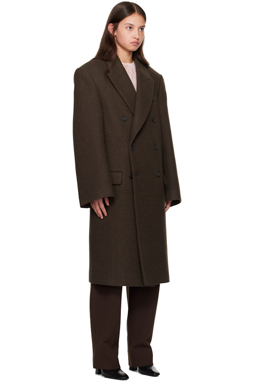 Wool melton coat.

· Peaked lapel
· Double-breasted button closure
· Welt pocket and flap pockets
· Padded shoulders
· Central vent at back hem
· Welt pocket at interior
· Full viscose satin lining

Part of the WARDROBE.NYC x Hailey Bieber collaboration.

Supplier color: Dark brown