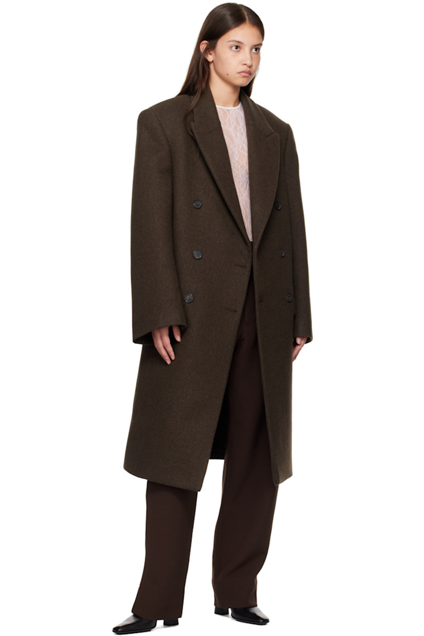 Wool melton coat.

· Peaked lapel
· Double-breasted button closure
· Welt pocket and flap pockets
· Padded shoulders
· Central vent at back hem
· Welt pocket at interior
· Full viscose satin lining

Part of the WARDROBE.NYC x Hailey Bieber collaboration.

Supplier color: Dark brown