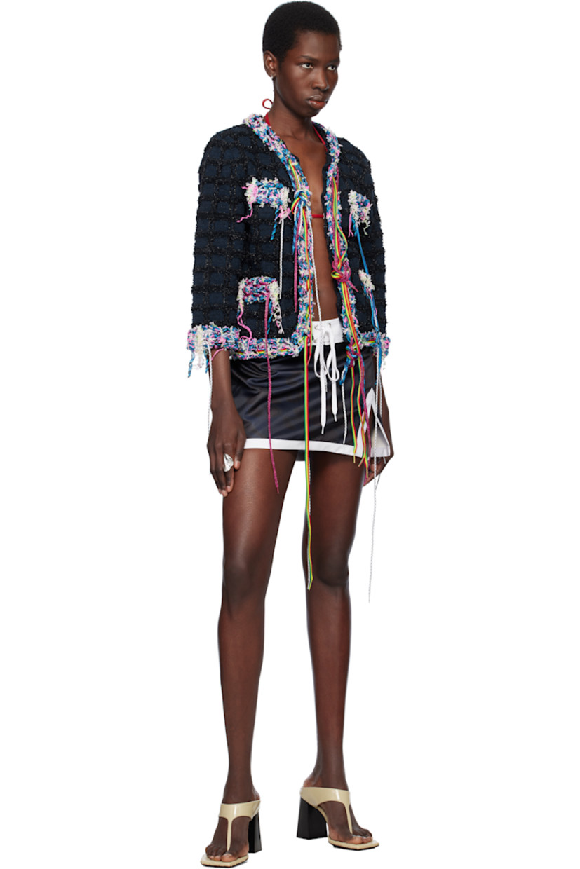 Recycled polyester sateen miniskirt. Poplin trim and printed floral pattern throughout. 

· Lace-up closure and locker loop at waistband
· Slit at front hem
· Concealed zip closure at side
· Flap pocket with eyelets at back 

Supplier color: Navy