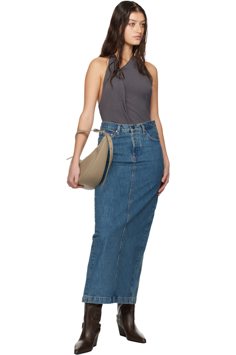 Non-stretch 14 oz denim midi skirt. Fading throughout.

· Belt loops
· Five-pocket styling
· Button fly
· Leather logo patch at back waistband
· Central vent at back hem
· Contrast stitching in tan

Supplier color: Indigo