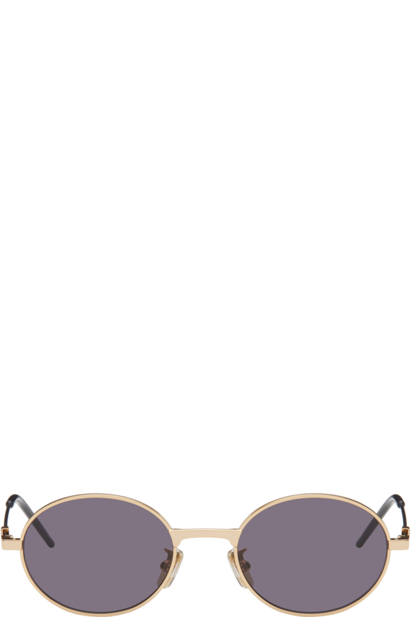 Round metal-frame sunglasses in gold tone.

· Gray lenses
· 100% UVA/UVB protection, Category 3
· Adjustable rubber nose pads
· Logo hardware at temples
· Logo etched at nylon temple tips
· Includes pouch
· Size: 51.20 145

Supplier color: Black/Golden