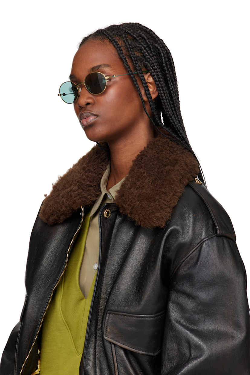 Round metal-frame sunglasses in gold tone.

· Green lenses
· 100% UVA/UVB protection, Category 3
· Adjustable rubber nose pads
· Logo hardware at temples
· Logo etched at nylon temple tips
· Includes pouch
· Size: 51.20 145

Supplier color: Green/Golden