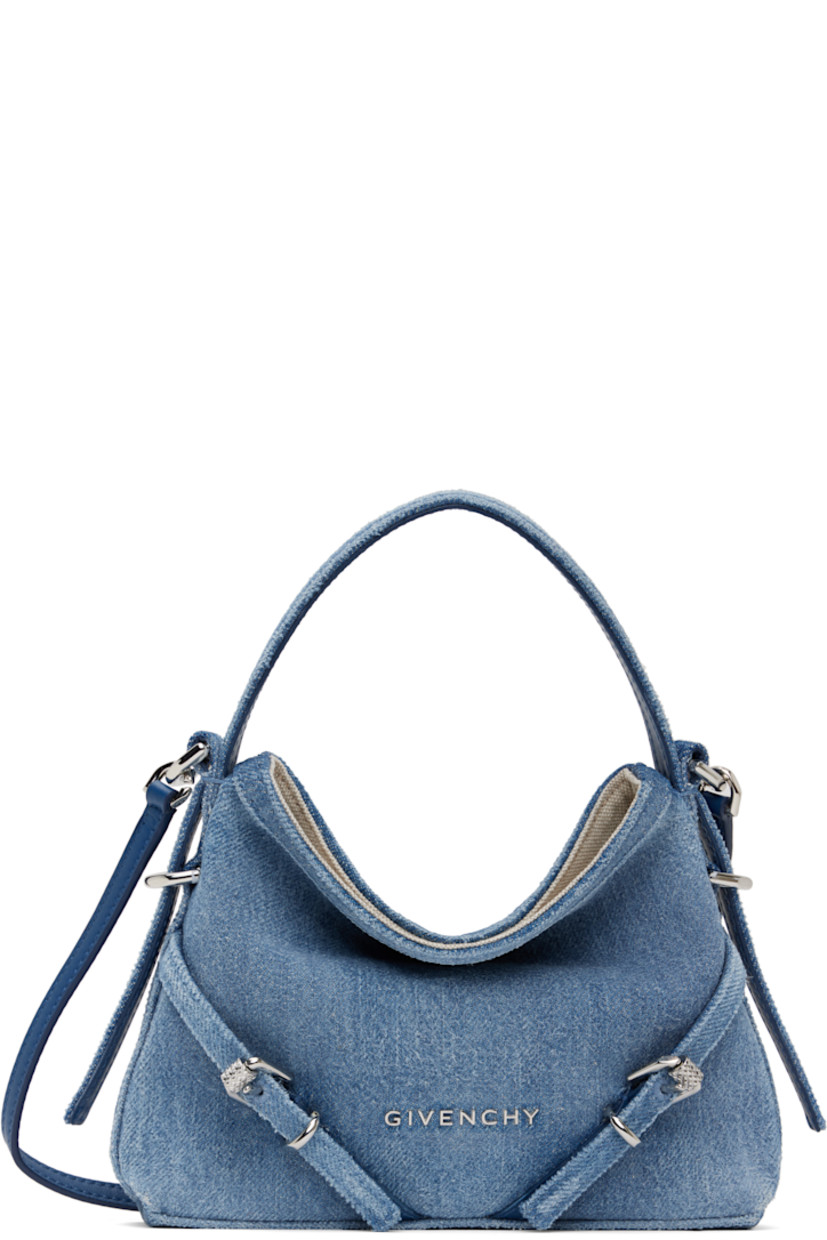 Non-stretch denim bag in blue. 

· Fading throughout
· Fixed carry handle
· Detachable crossbody strap
· Logo hardware and pin-buckle straps at face
· Canvas lining
· H5.75" x W7.25" x D1.25"

Supplier color: Medium blue