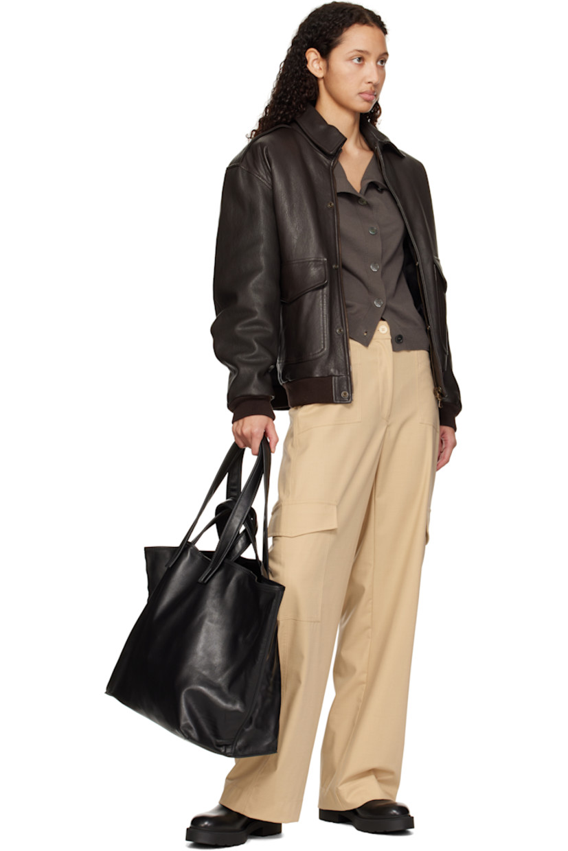 Buffed calfskin tote in black.

· Fixed carry handles and shoulder straps
· Lanyard-clasp closure
· Flap and zip pocket at interior
· Buffed leather, suede, and faille lining
· H14" x W24" x D8"

Supplier color: Black