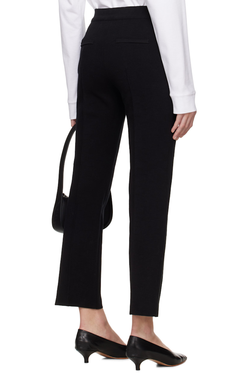 Knit stretch cotton-blend trousers. Jacquard check pattern throughout.

· Elasticized waistband
· Pinched seam at legs
· Mock welt pockets at back

Supplier color: Black