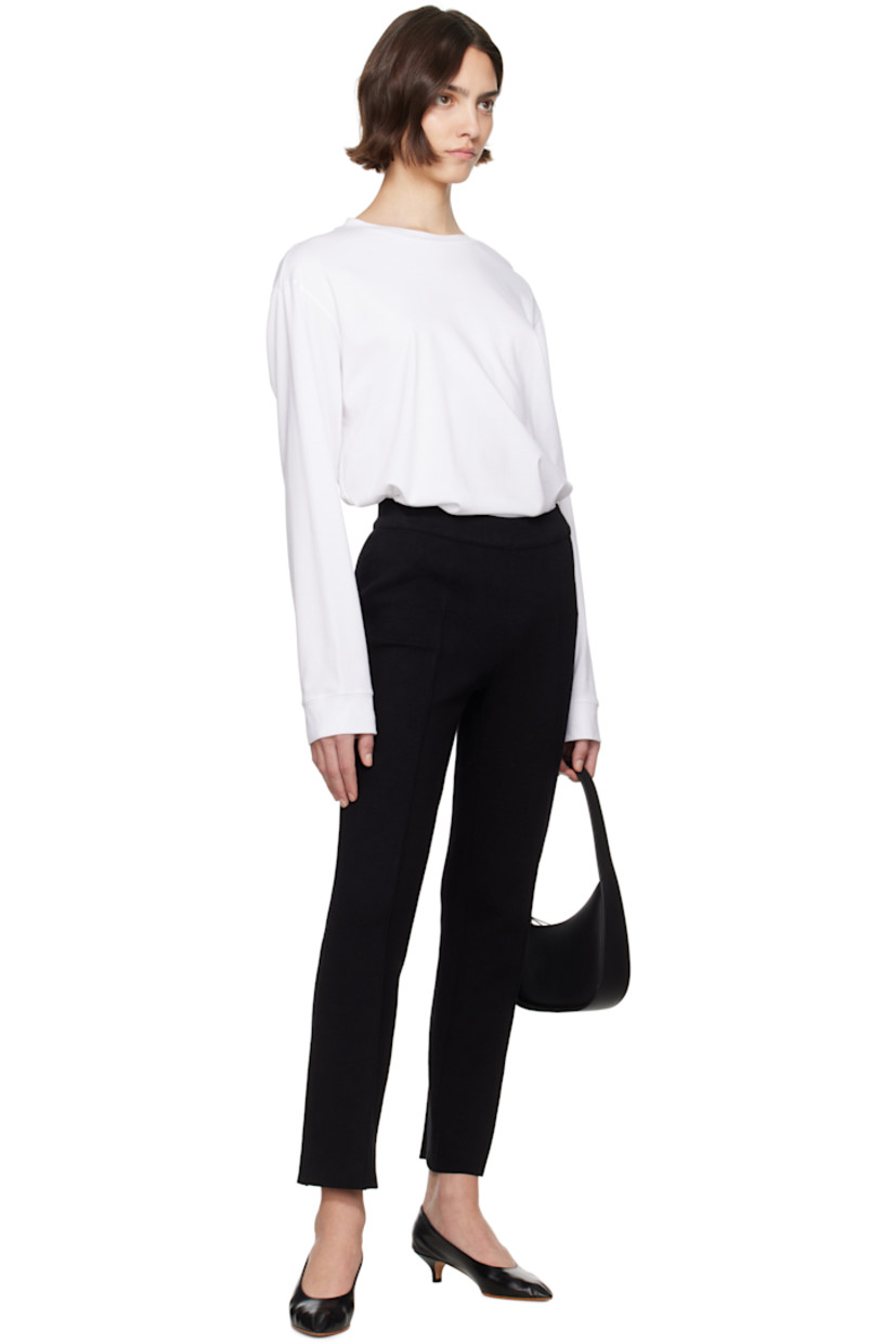 Knit stretch cotton-blend trousers. Jacquard check pattern throughout.

· Elasticized waistband
· Pinched seam at legs
· Mock welt pockets at back

Supplier color: Black