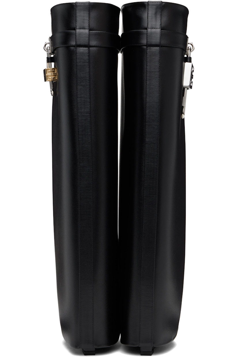 Knee-high grained calfskin slip-on boots in black.

· Layered construction
· Pointed toe
· Logo padlock at outer side
· Buffed goatskin lining
· Covered wedge heel with rubber injection
· Polished faux-leather sole
· Logo-engraved silver- and gold-tone hardware
· Heel: H3.5"

Supplier color: Black