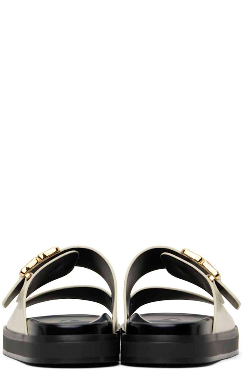 Patent calfskin flat sandals in off-white.

· Open square toe
· Logo post-stud strap at vamp
· Logo stamp at polished leather footbed
· Grained leather lining
· Treaded rubber sole

Supplier color: Ivory