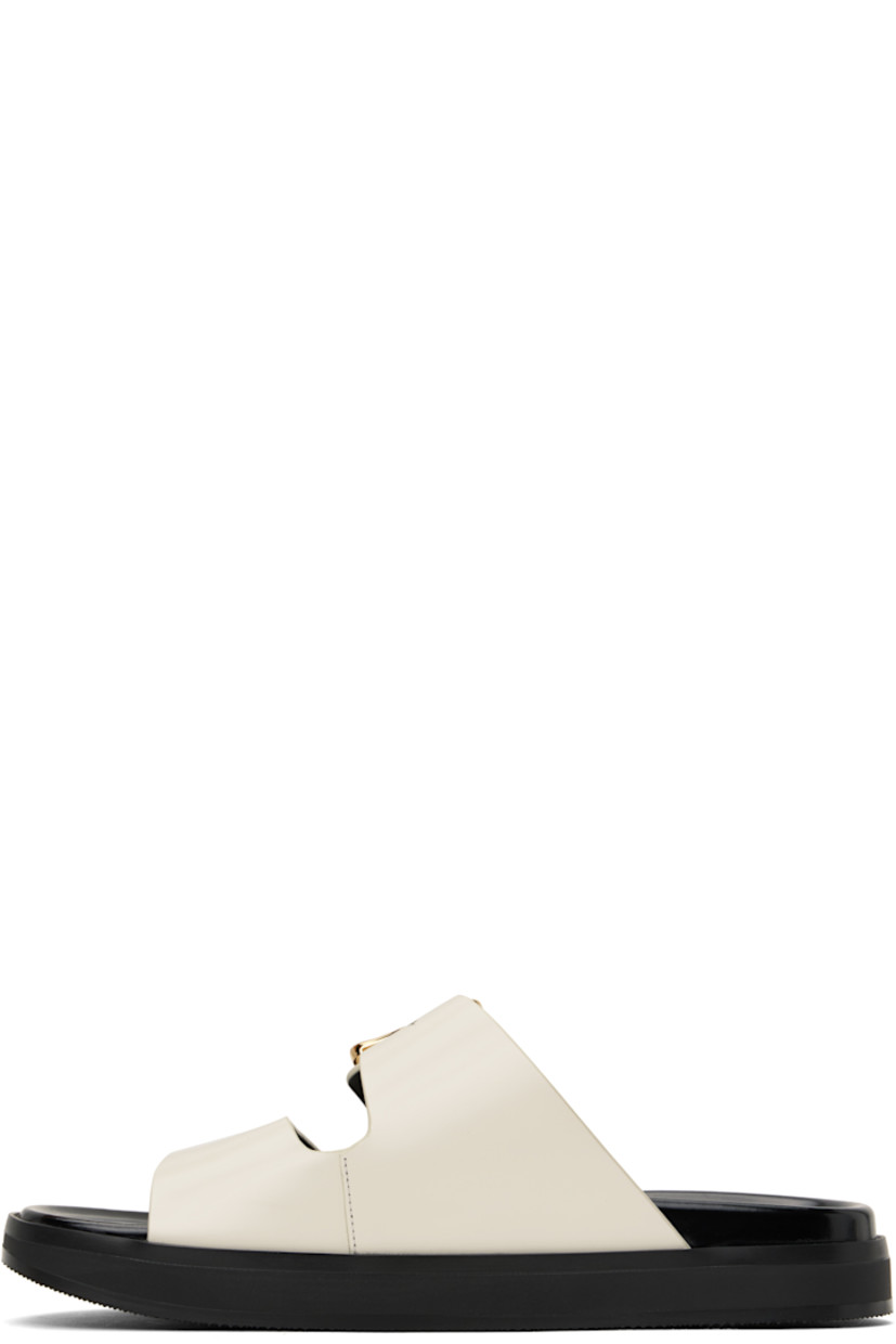 Patent calfskin flat sandals in off-white.

· Open square toe
· Logo post-stud strap at vamp
· Logo stamp at polished leather footbed
· Grained leather lining
· Treaded rubber sole

Supplier color: Ivory