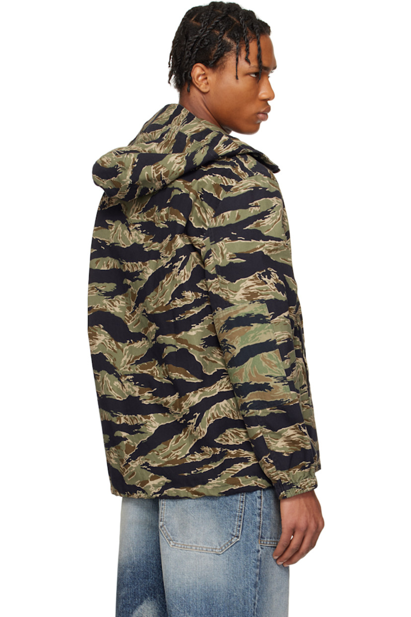 Cotton canvas jacket. Camouflage pattern printed throughout. 

· Bungee-style drawstring at brimmed hood
· Stand collar
· Zip closure
· Embroidered logo patch at chest
· Welt pockets
· Concealed bungee-style drawstring at hem
· Flap pocket at sleeve
· Elasticized cuffs
· Unlined 
· Logo-engraved oxidized gunmetal-tone hardware

Supplier color: Multicolored