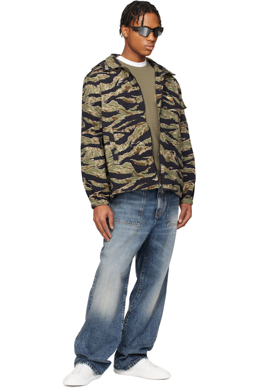 Cotton canvas jacket. Camouflage pattern printed throughout. 

· Bungee-style drawstring at brimmed hood
· Stand collar
· Zip closure
· Embroidered logo patch at chest
· Welt pockets
· Concealed bungee-style drawstring at hem
· Flap pocket at sleeve
· Elasticized cuffs
· Unlined 
· Logo-engraved oxidized gunmetal-tone hardware

Supplier color: Multicolored