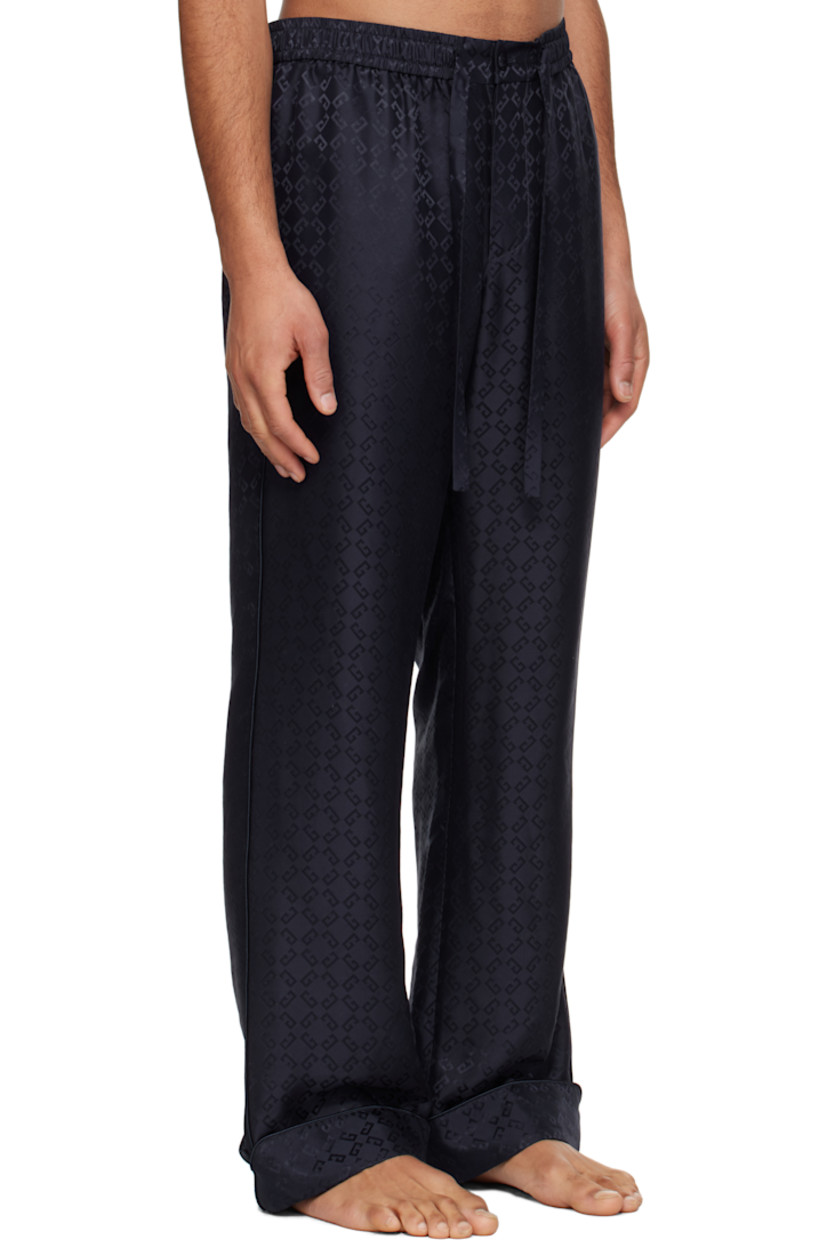 Loose-fit silk poplin pyjama pants. Jacquard logo pattern throughout.

· Drawstring at elasticized waistband
· Three-pocket styling
· Button fly
· Rolled cuffs
· Piping at outseams and back pocket

Supplier color: Dark blue