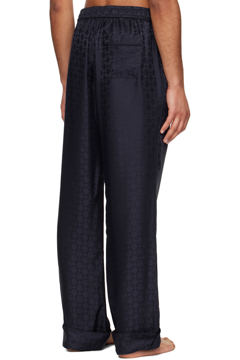 Loose-fit silk poplin pyjama pants. Jacquard logo pattern throughout.

· Drawstring at elasticized waistband
· Three-pocket styling
· Button fly
· Rolled cuffs
· Piping at outseams and back pocket

Supplier color: Dark blue
