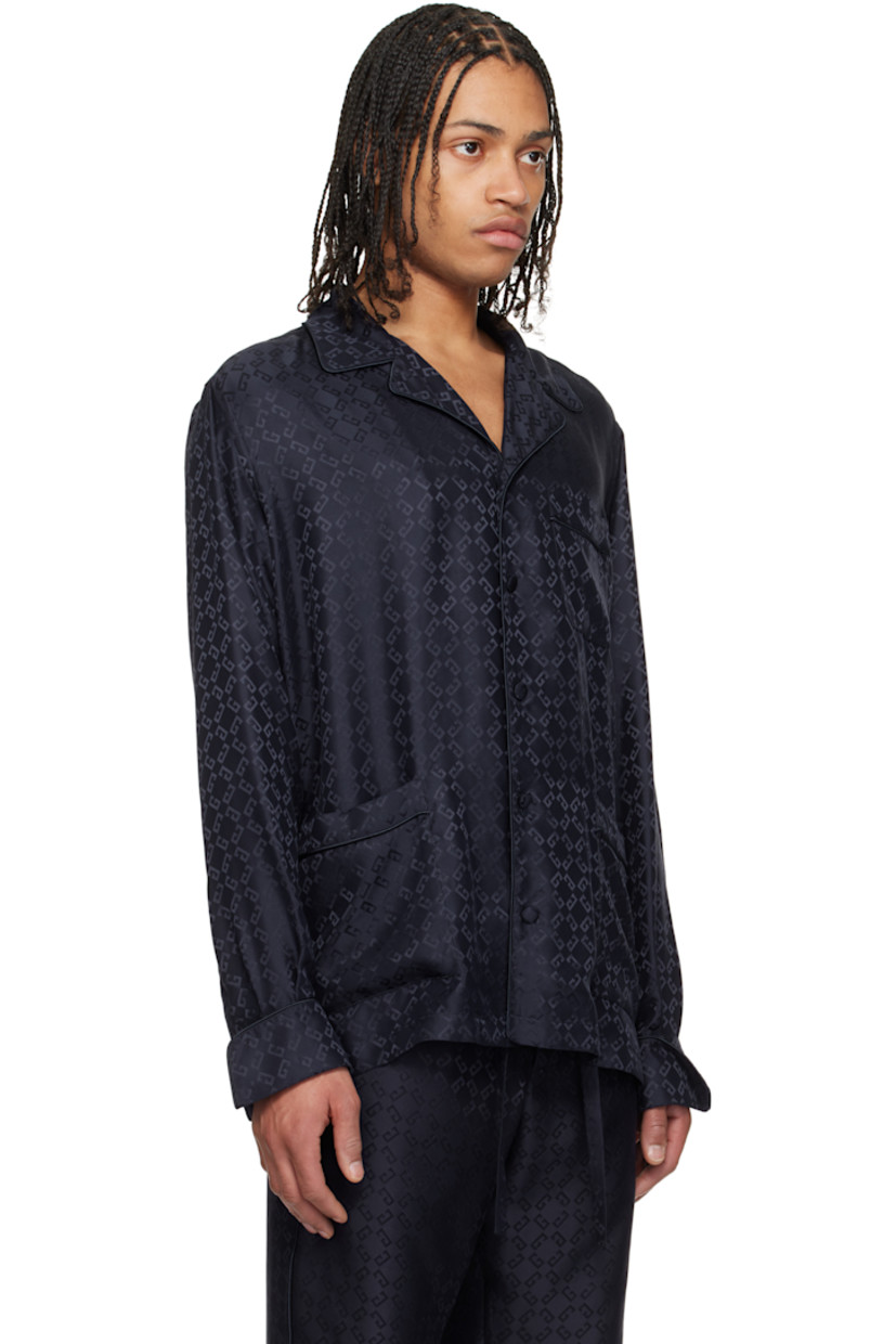 Loose-fit silk poplin pyjama shirt. Piping and jacquard logo pattern throughout.

· Open spread collar
· Button closure
· Patch pockets
· Vented side seams
· Dropped shoulders
· Pleats at single-button barrel cuffs
· Twin pleats at back yoke

Supplier color: Dark blue
