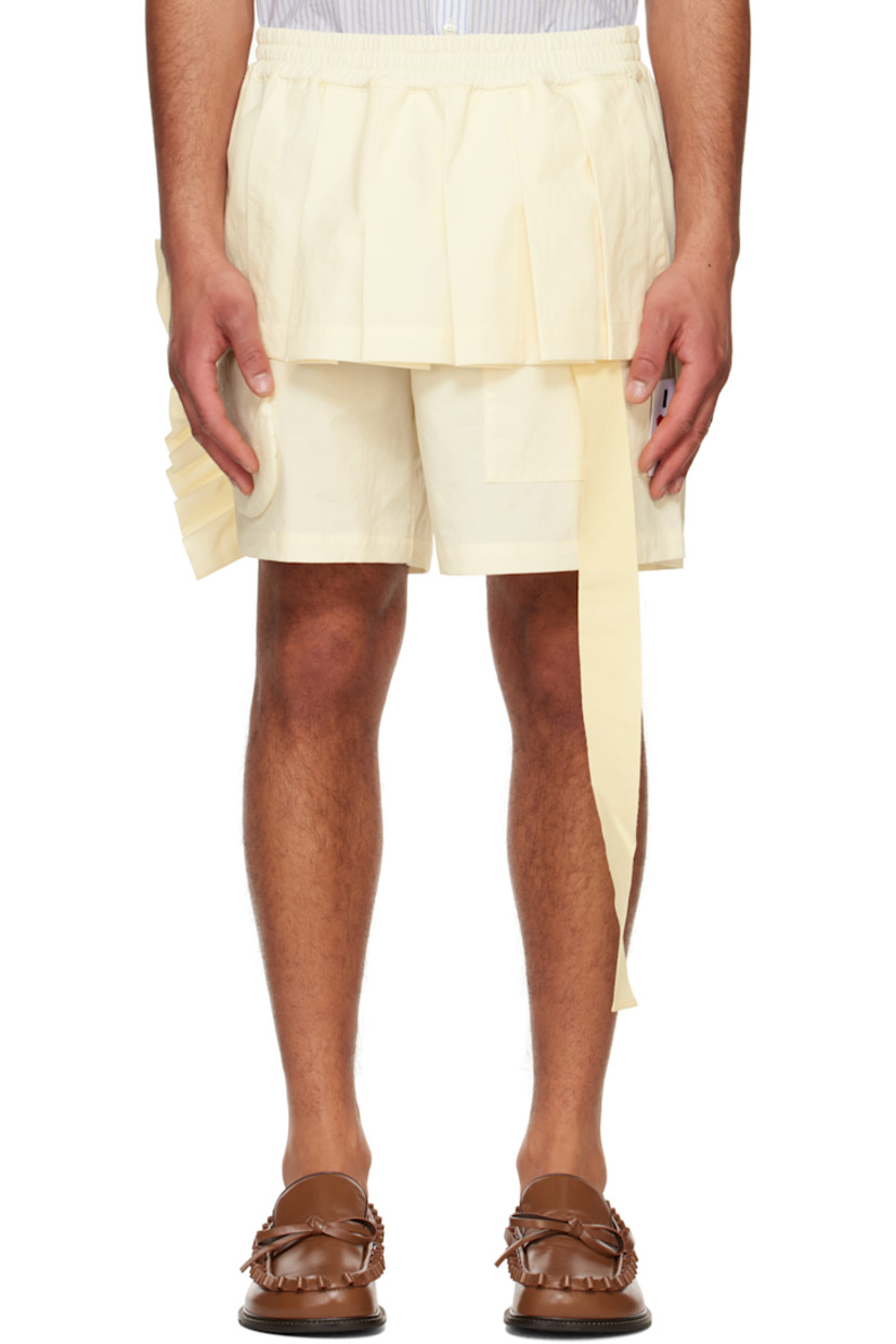 Nylon canvas shorts.

· Elasticized waistband
· Four-pocket styling
· Pleated skirt-style overlay at front waistband
· Extended grosgrain trim at waistband
· Circular appliqué at front cuff
· Ruffled trim at outseam
· Logo flag at outseam
· Padded overlay with inset graphic patches at back

Supplier color: Comb. II/Off-white
