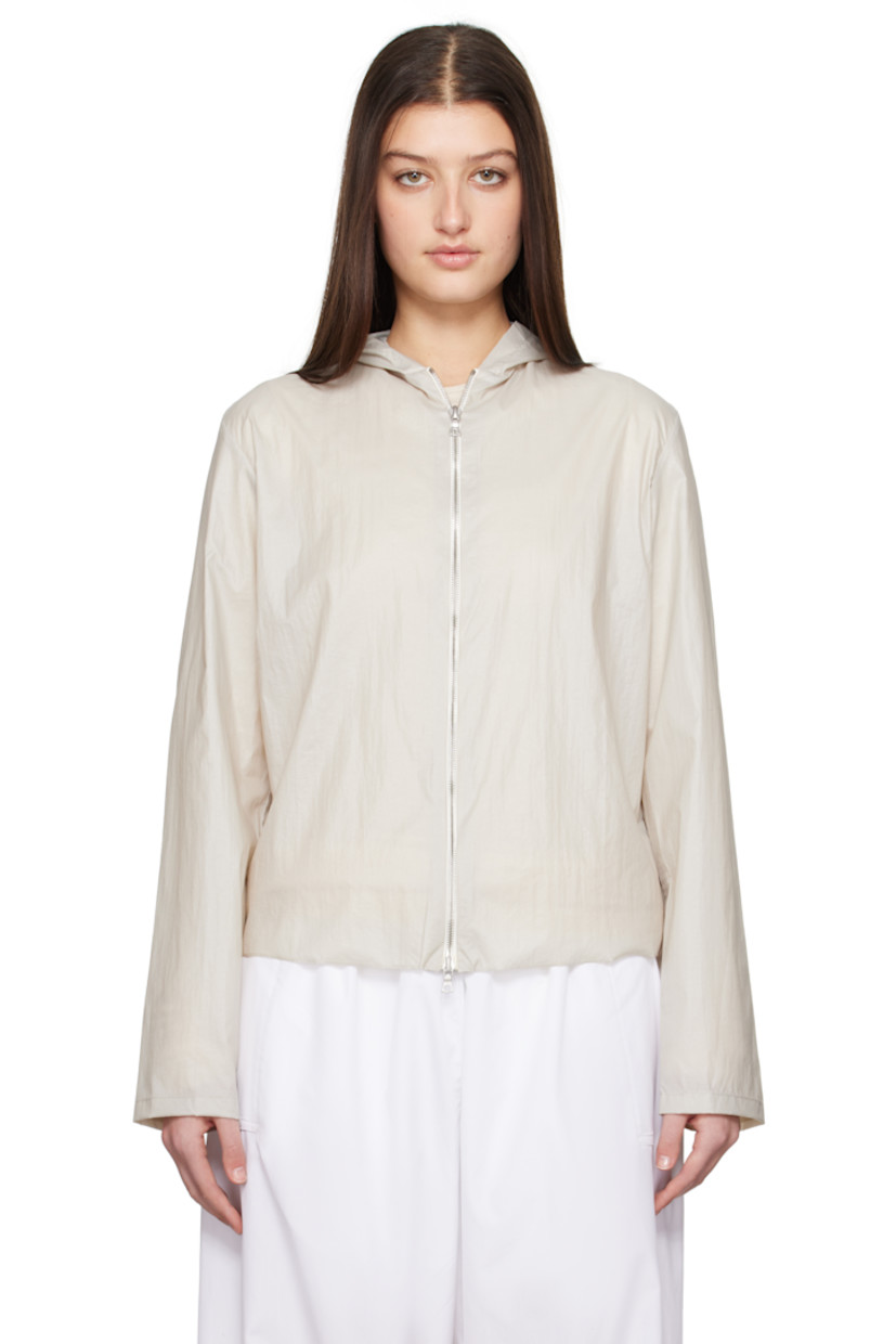 Handcrafted coated nylon taffeta jacket. 

· Hood at collar
· Two-way zip closure
· Unlined

Supplier color: Stone