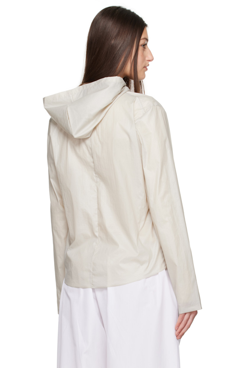 Handcrafted coated nylon taffeta jacket. 

· Hood at collar
· Two-way zip closure
· Unlined

Supplier color: Stone