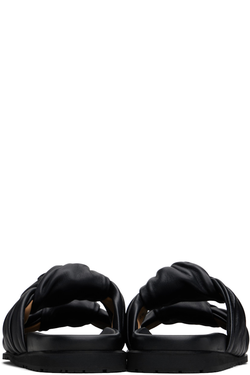 Handcrafted grained leather flat sandals in black.

· Open toe
· Straps with knotted detailing at vamp
· Logo stamp at molded footbed
· Treaded rubber sole

Supplier color: Black
