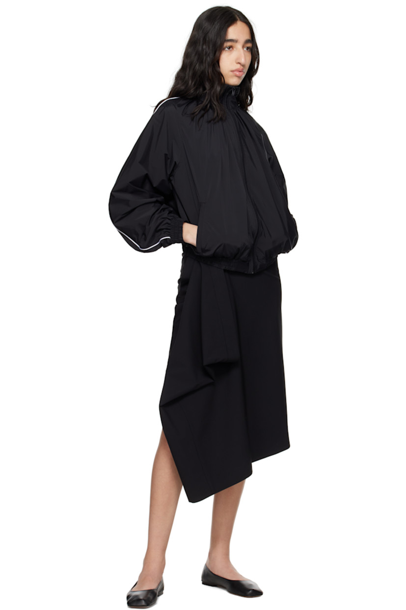 Stretch virgin wool-blend grain de poudre midi skirt.

· Wrap construction
· Single-pocket styling
· Button fastening at waistband
· Slit at back hem

Supplier color: Black