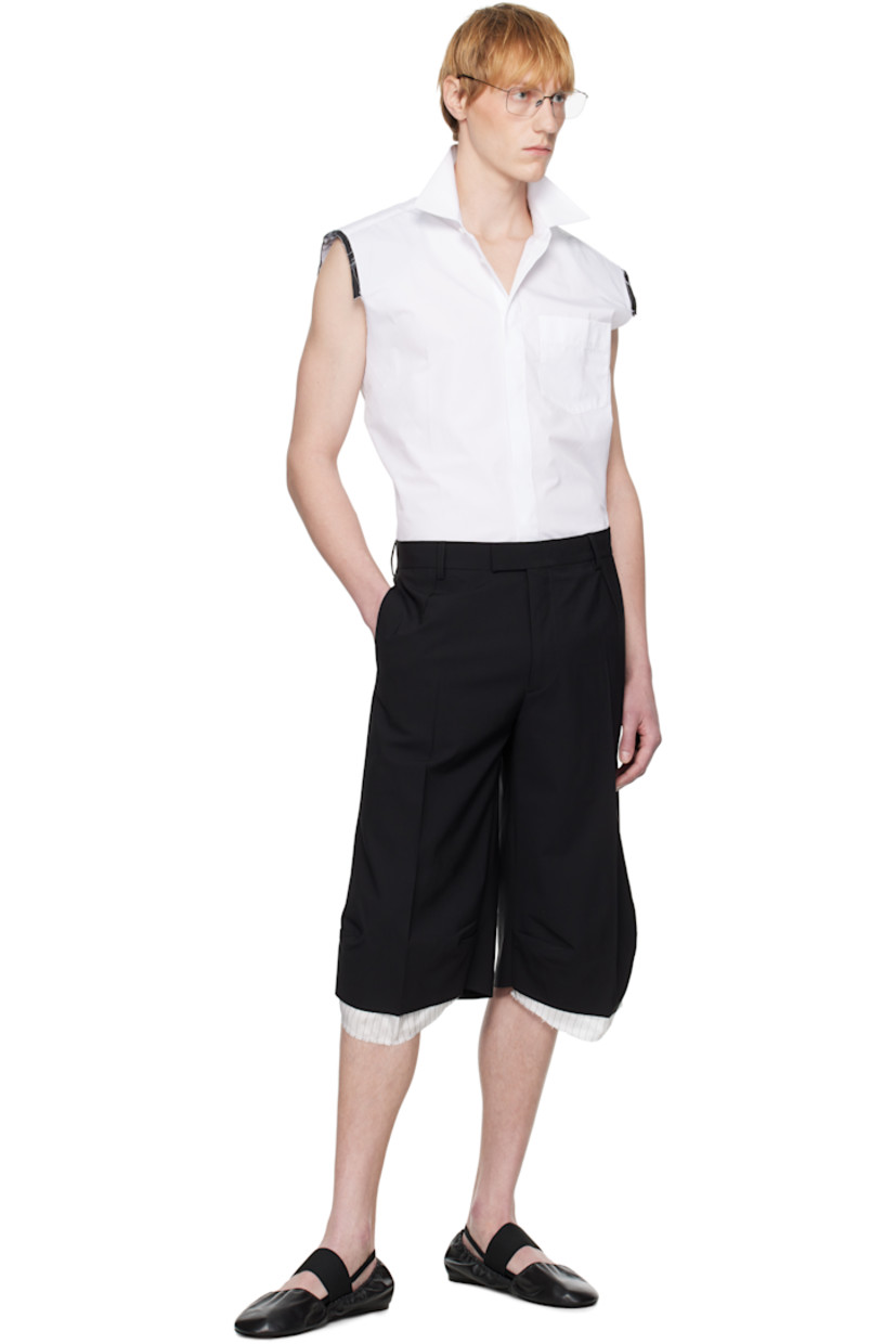 Cotton poplin shirt. 

· Spread collar
· Button closure
· Logo embroidered at patch pocket
· Shirttail hem
· Exposed layered trim at shoulders
· Raw edge at armscyes
· Box pleat at back yoke
· Mother-of-pearl hardware

Supplier color: White