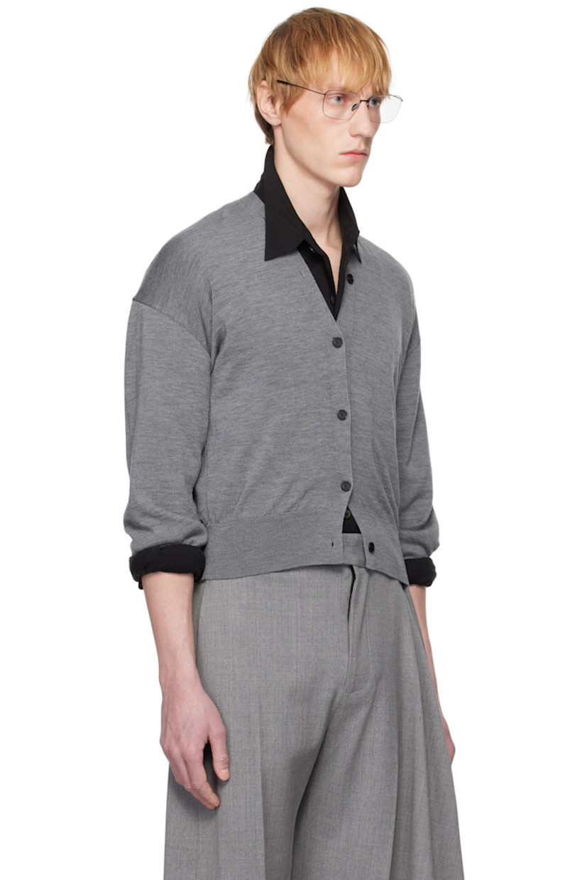 Knit merino wool cardigan.

· Rib-knit Y-neck, hem, and cuffs
· Button closure extends to collar
· Dropped shoulders
· Logo-engraved hardware

Supplier color: Grey china