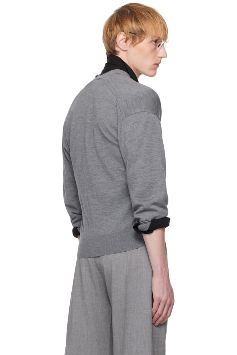 Knit merino wool cardigan.

· Rib-knit Y-neck, hem, and cuffs
· Button closure extends to collar
· Dropped shoulders
· Logo-engraved hardware

Supplier color: Grey china