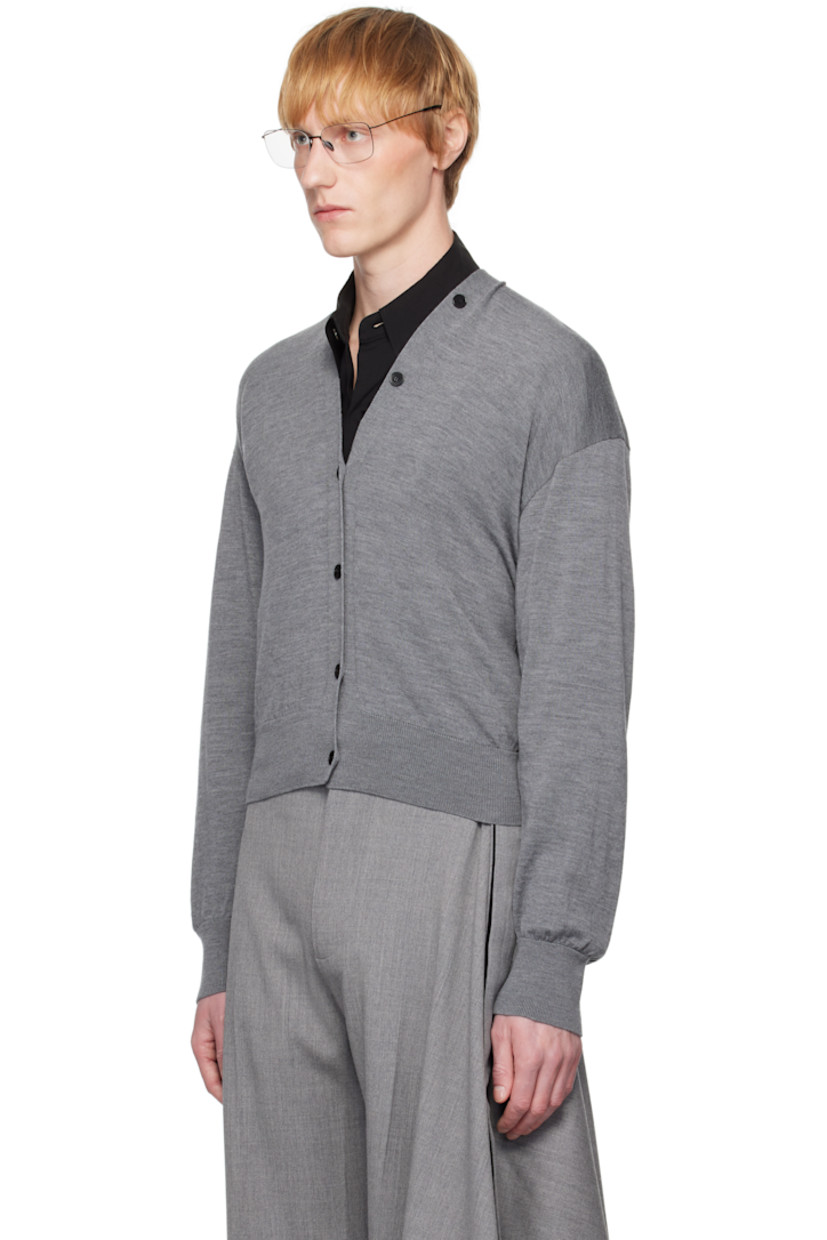 Knit merino wool cardigan.

· Rib-knit Y-neck, hem, and cuffs
· Button closure extends to collar
· Dropped shoulders
· Logo-engraved hardware

Supplier color: Grey china