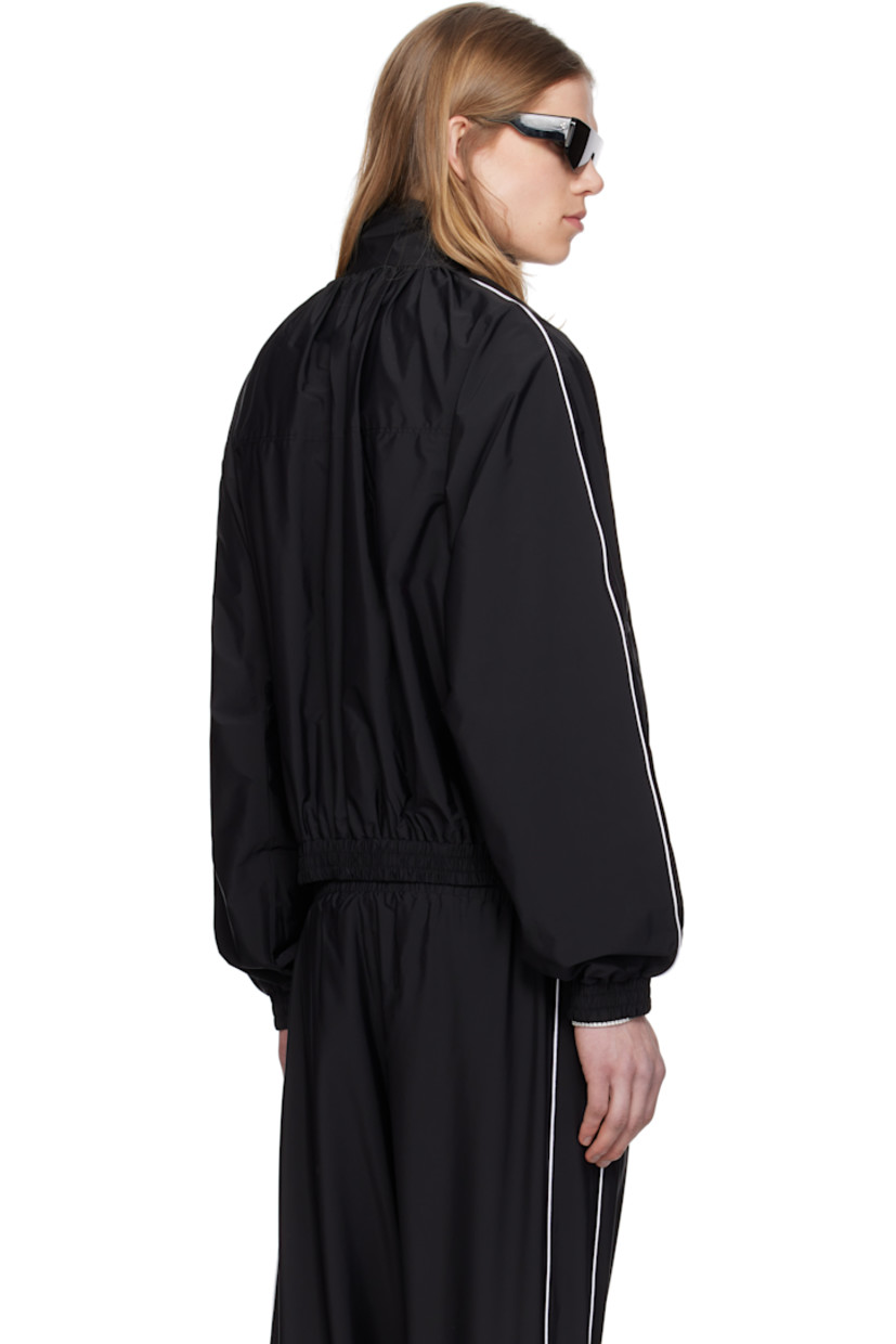 Stretch nylon taffeta track jacket.

· Gathering at stand collar
· Zip closure
· Zip pockets
· Elasticized hem and cuffs
· Piping at sleeves
· Rubberized logo patch at sleeve
· Full cotton jersey lining

Supplier color: Black
