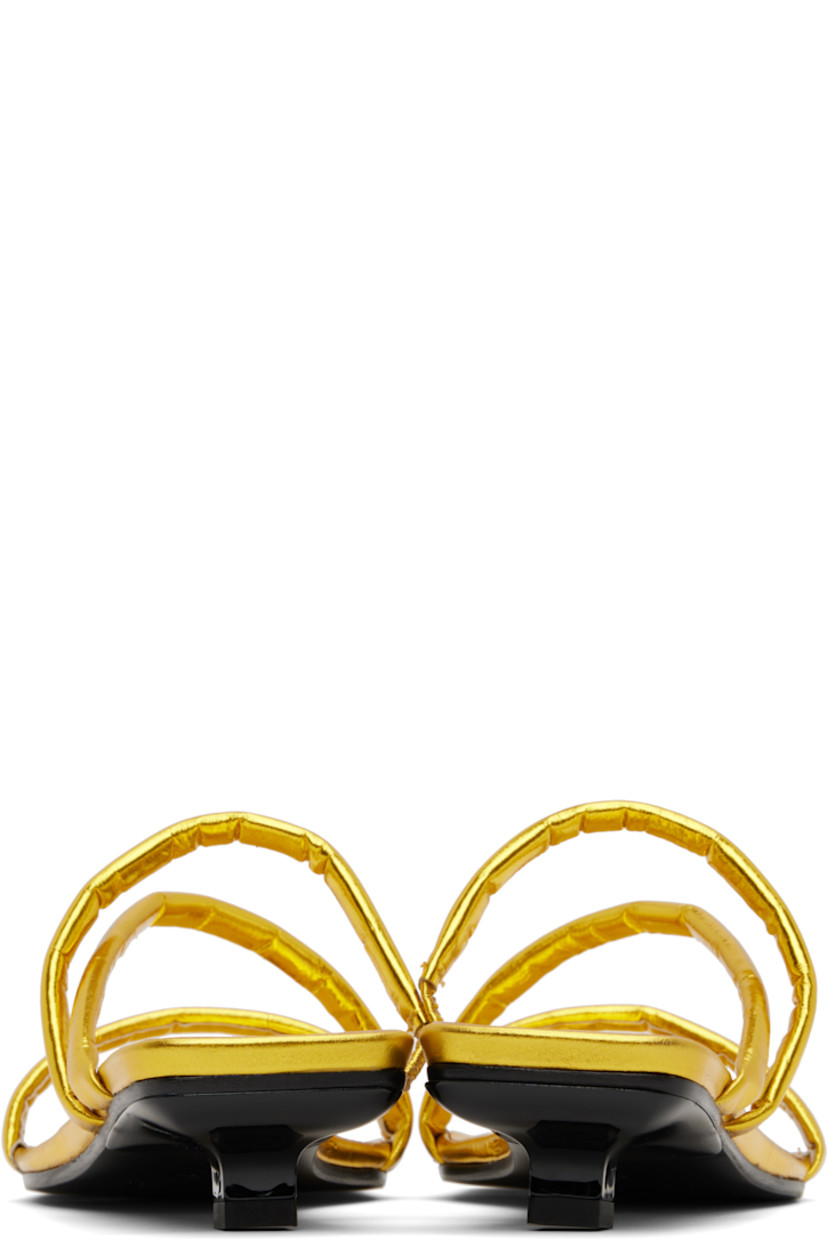 Eel-embossed leather heeled sandals in metallic gold tone. 

· Open square toe
· Padded and partially elasticized straps at vamp
· Logo embossed at molded footbed
· Covered kitten heel with rubber injection
· Polished leather sole
· Heel: H1.25"

Supplier color: Yellow gold