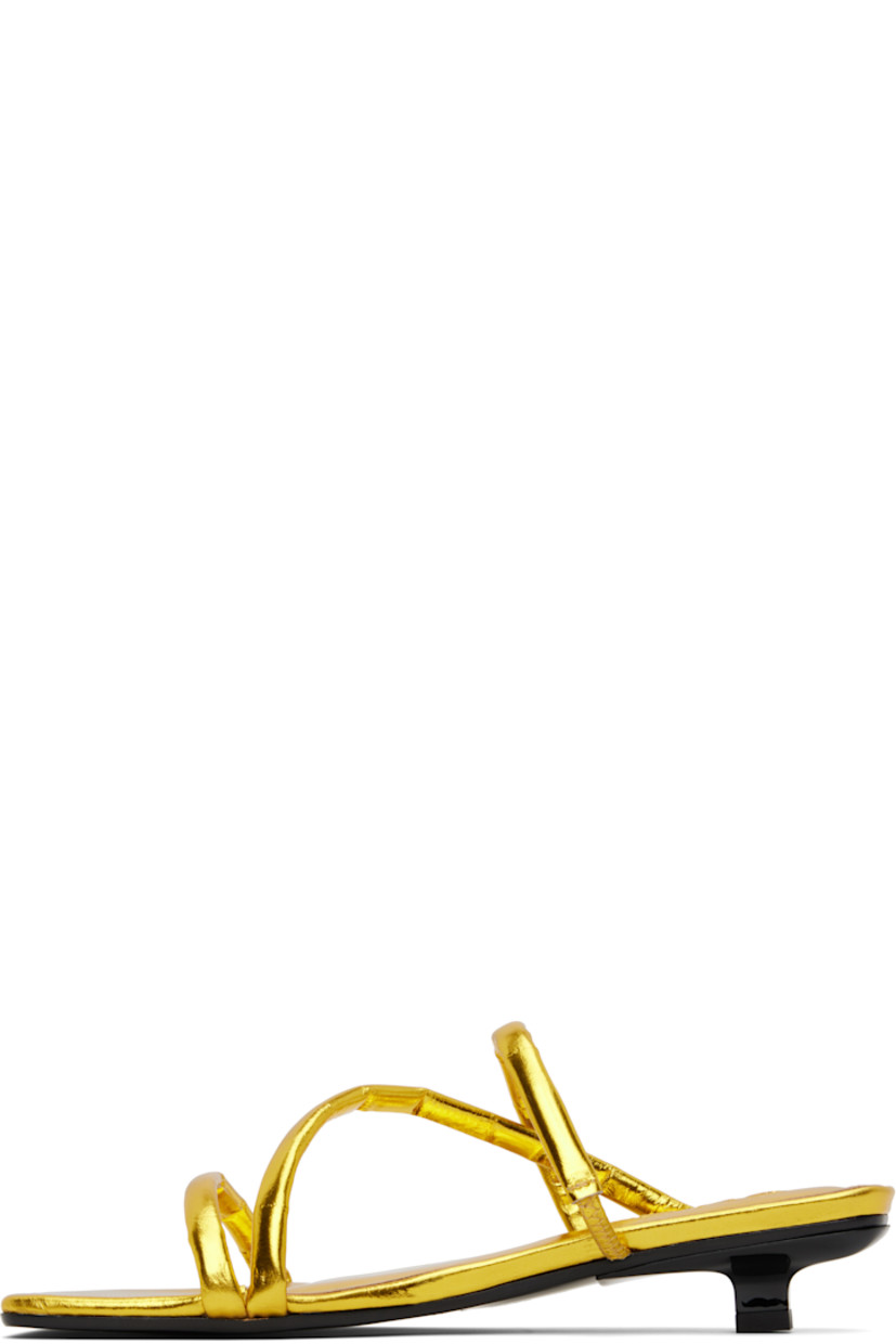 Eel-embossed leather heeled sandals in metallic gold tone. 

· Open square toe
· Padded and partially elasticized straps at vamp
· Logo embossed at molded footbed
· Covered kitten heel with rubber injection
· Polished leather sole
· Heel: H1.25"

Supplier color: Yellow gold