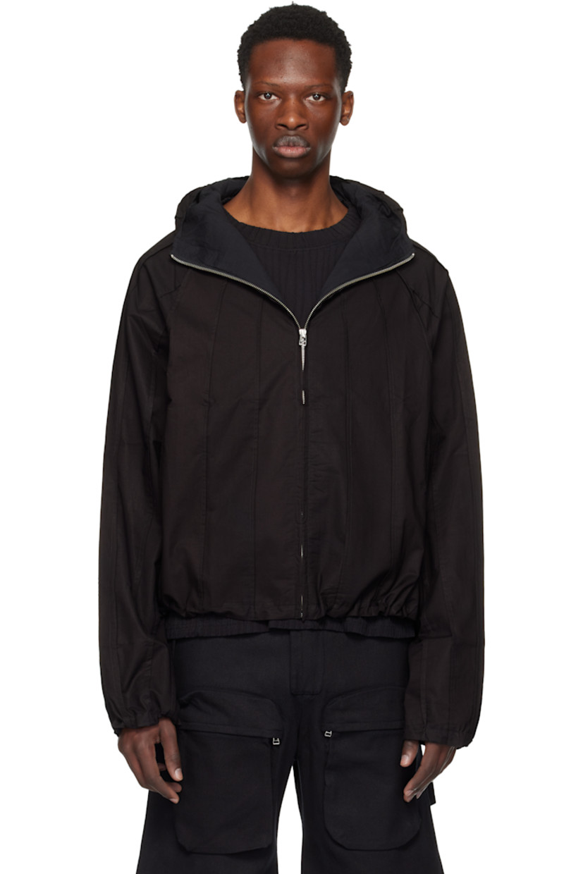 Plain-woven cotton jacket. Pinched seams throughout.

· Hood at stand collar
· Concealed zip closure
· Seam pockets
· Concealed bungee-style drawstring at hem and cuffs
· Raglan sleeves
· Full broadcloth lining

Supplier color: Meteorite