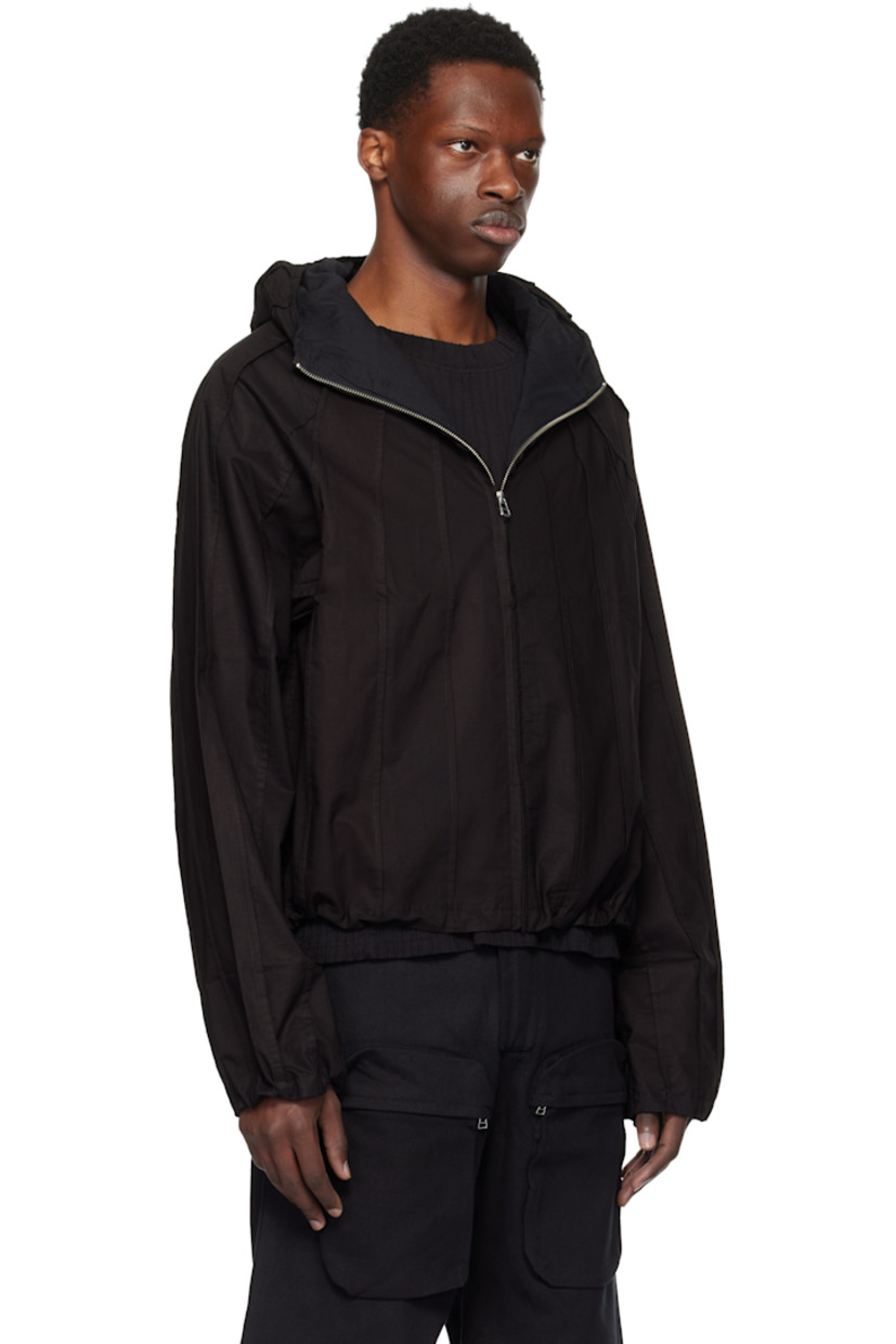 Plain-woven cotton jacket. Pinched seams throughout.

· Hood at stand collar
· Concealed zip closure
· Seam pockets
· Concealed bungee-style drawstring at hem and cuffs
· Raglan sleeves
· Full broadcloth lining

Supplier color: Meteorite