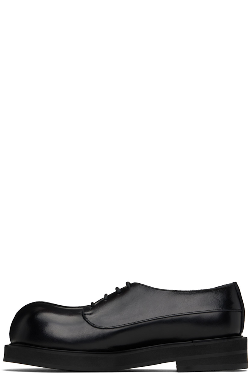 Handcrafted polished calfskin derbys in black.

· Pinched seam at vamp
· Lace-up closure
· Buffed leather lining
· Stacked foam rubber heel and midsole
· Vibram® rubber sole
· Heel: H1.5"

Supplier color: Plane black