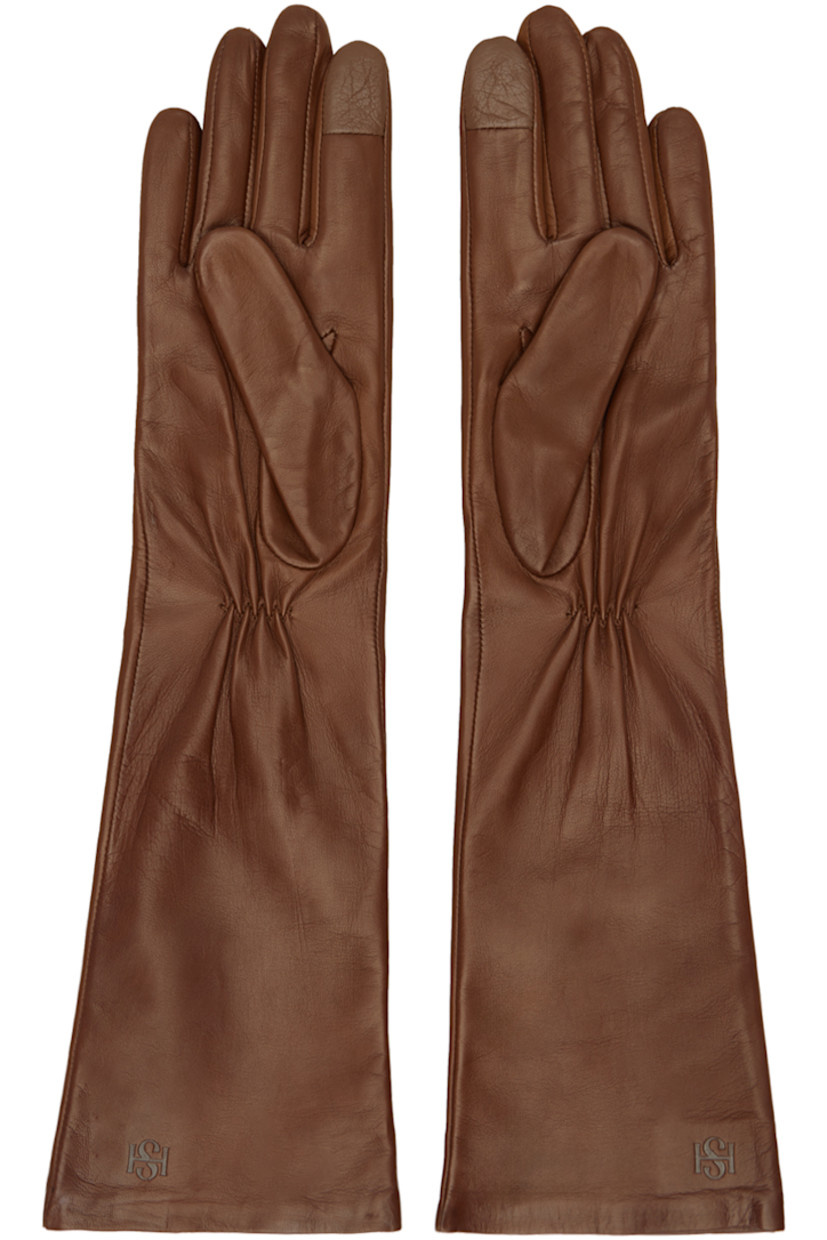 Pair of handcrafted nappa leather gloves in brown.

· Gathering and logo embossed at back face
· Touchscreen compatible index finger
· Silk jersey lining

Supplier color: Saddle brown