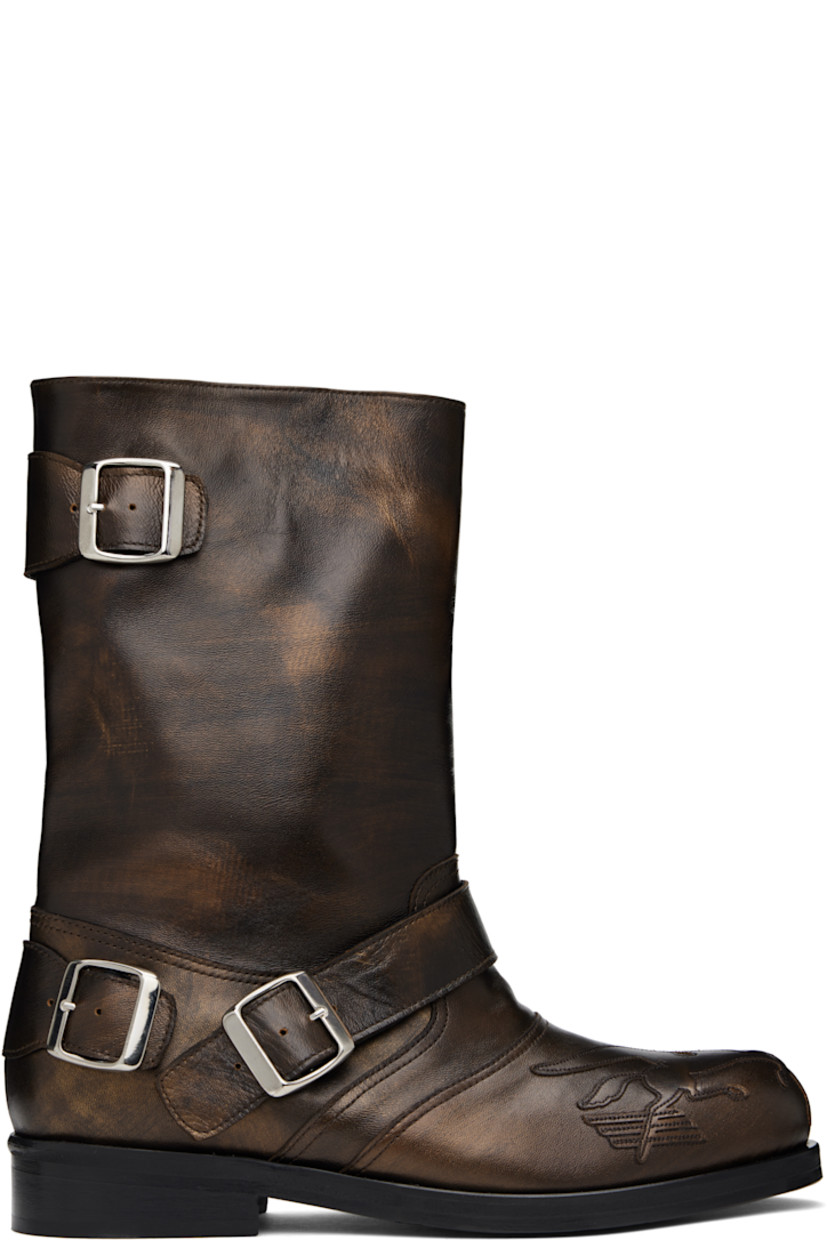 Mid-calf buffed leather slip-on boots in metallic brown. Pin-buckle straps at vamp, outer side, and heel counter.

· Graphic appliqué at toe
· Stacked leather heel with rubber injection
· Polished leather sole

Supplier color: Brown