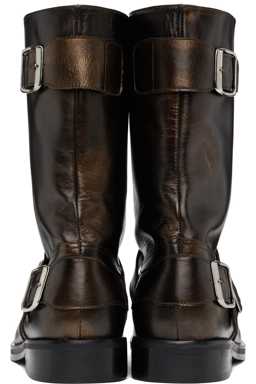 Mid-calf buffed leather slip-on boots in metallic brown. Pin-buckle straps at vamp, outer side, and heel counter.

· Graphic appliqué at toe
· Stacked leather heel with rubber injection
· Polished leather sole

Supplier color: Brown