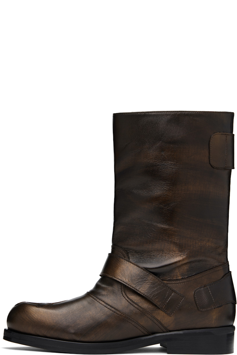 Mid-calf buffed leather slip-on boots in metallic brown. Pin-buckle straps at vamp, outer side, and heel counter.

· Graphic appliqué at toe
· Stacked leather heel with rubber injection
· Polished leather sole

Supplier color: Brown