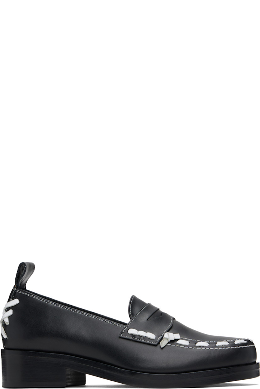 Buffed leather loafers in black.

· Lace-up detailing at moc toe and heel
· Strap with cutout at vamp
· Pull-loop at heel collar
· Stacked leather heel with rubber injection
· Leather sole
· Contrast stitching in white
· Heel: H1.5"

Supplier color: Black