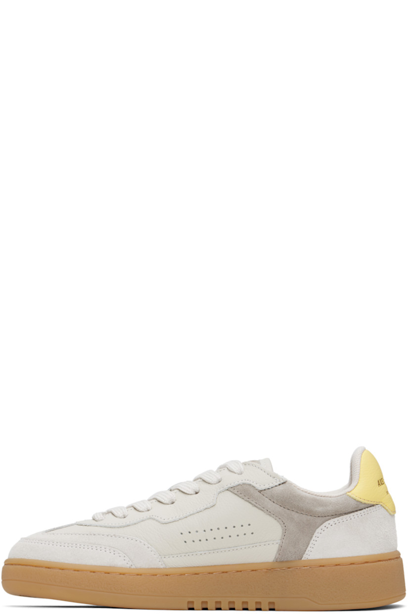 Handcrafted low-top grained leather and suede sneakers in gray.

· Lace-up closure
· Logo patch at padded canvas tongue
· Padded collar
· Perforations at sides
· Logo stamp at outer side and heel tab 
· Mesh and faux-suede lining
· Logo embossed at textured rubber midsole
· Treaded rubber sole

Supplier color: Beige/Gum