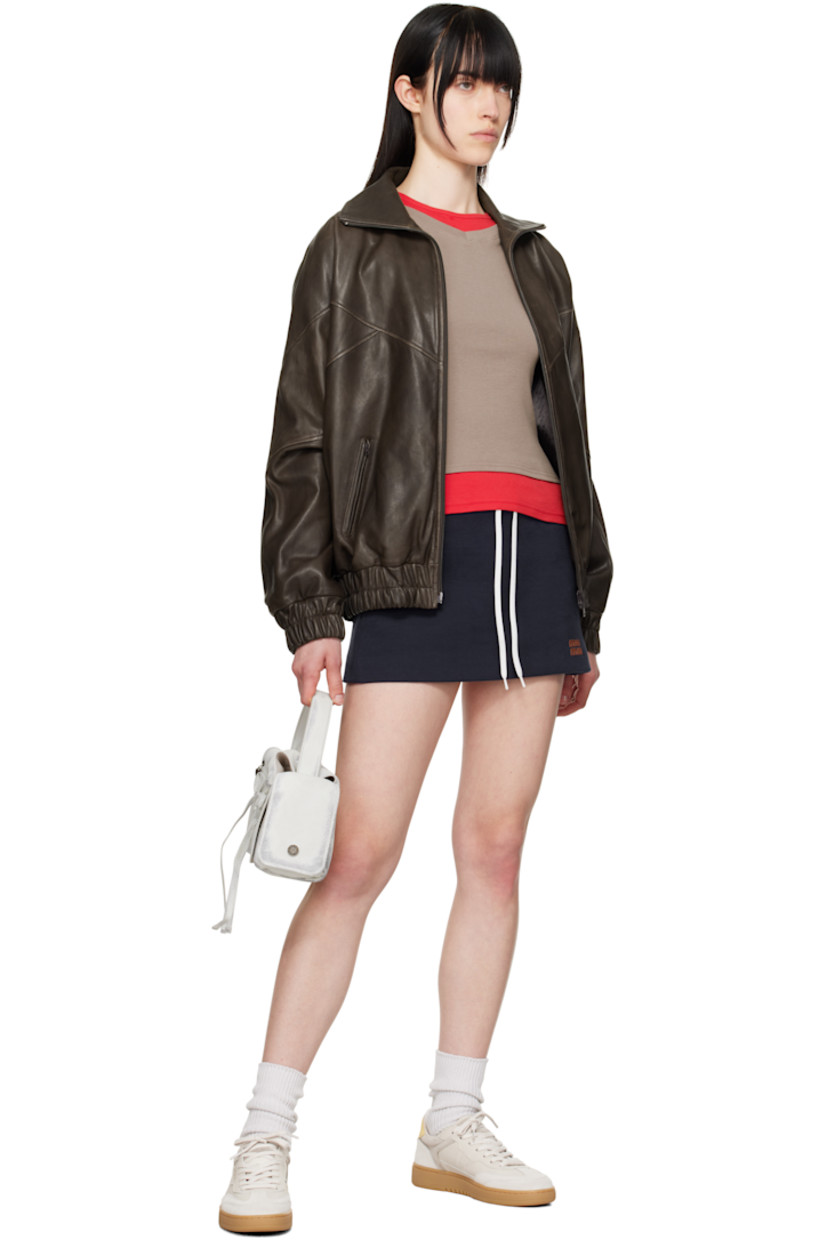 Handcrafted low-top grained leather and suede sneakers in gray.

· Lace-up closure
· Logo patch at padded canvas tongue
· Padded collar
· Perforations at sides
· Logo stamp at outer side and heel tab 
· Mesh and faux-suede lining
· Logo embossed at textured rubber midsole
· Treaded rubber sole

Supplier color: Beige/Gum