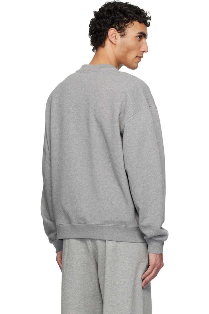Organic cotton French terry sweatshirt.

· Rib-knit crewneck, hem, and cuffs
· Logo and text appliqués at front
· Dropped shoulders

Supplier color: Grey melange