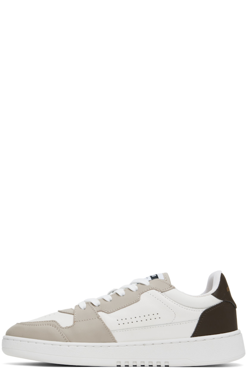 Handcrafted low-top buffed and grained leather sneakers in white and taupe. 

· Perforated detailing at toe and sides
· Lace-up closure
· Logo patch at padded tongue
· Logo stamp at outer side and heel tab
· Recycled mesh lining
· Logo embossed at crêpe rubber midsole
· Treaded rubber sole

Supplier color: White/Dark brown