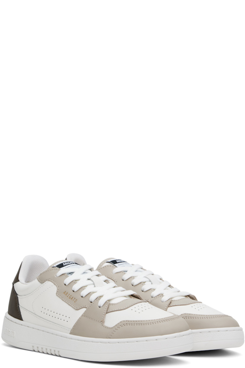 Handcrafted low-top buffed and grained leather sneakers in white and taupe. 

· Perforated detailing at toe and sides
· Lace-up closure
· Logo patch at padded tongue
· Logo stamp at outer side and heel tab
· Recycled mesh lining
· Logo embossed at crêpe rubber midsole
· Treaded rubber sole

Supplier color: White/Dark brown