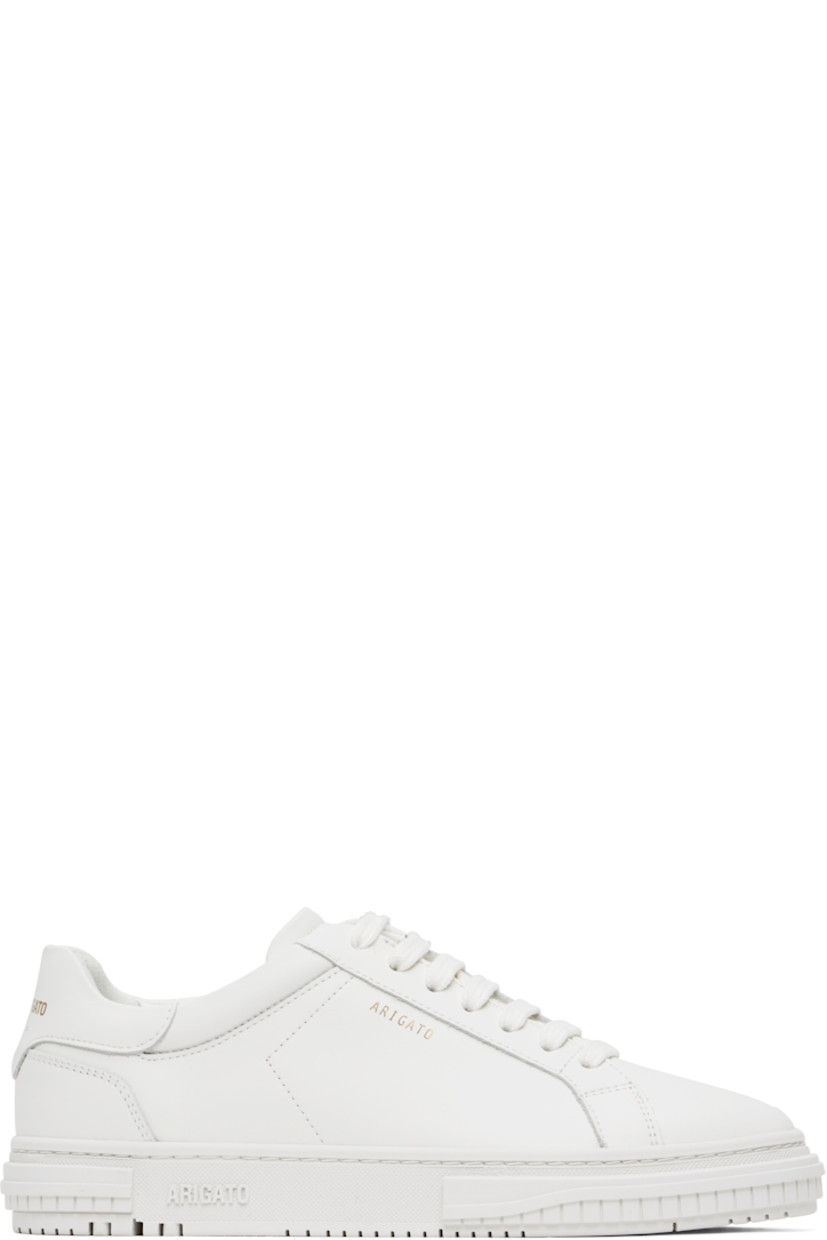 Handcrafted low-top buffed leather sneakers in white. 

· Lace-up closure
· Padded tongue and collar
· Logo stamp at outer side and heel tab
· Buffed leather and suede lining
· Logo embossed at textured rubber midsole
· Treaded rubber sole

Supplier color: White