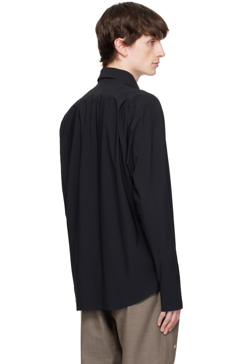 Stretch nylon jersey shirt. Laser-cut raw edges and taped seams throughout.

· Spread collar
· Button closure 
· Flap pockets at chest
· Logo embroidered at shirttail hem
· Barrel cuffs
· Twin pleats at back yoke

Supplier color: Black