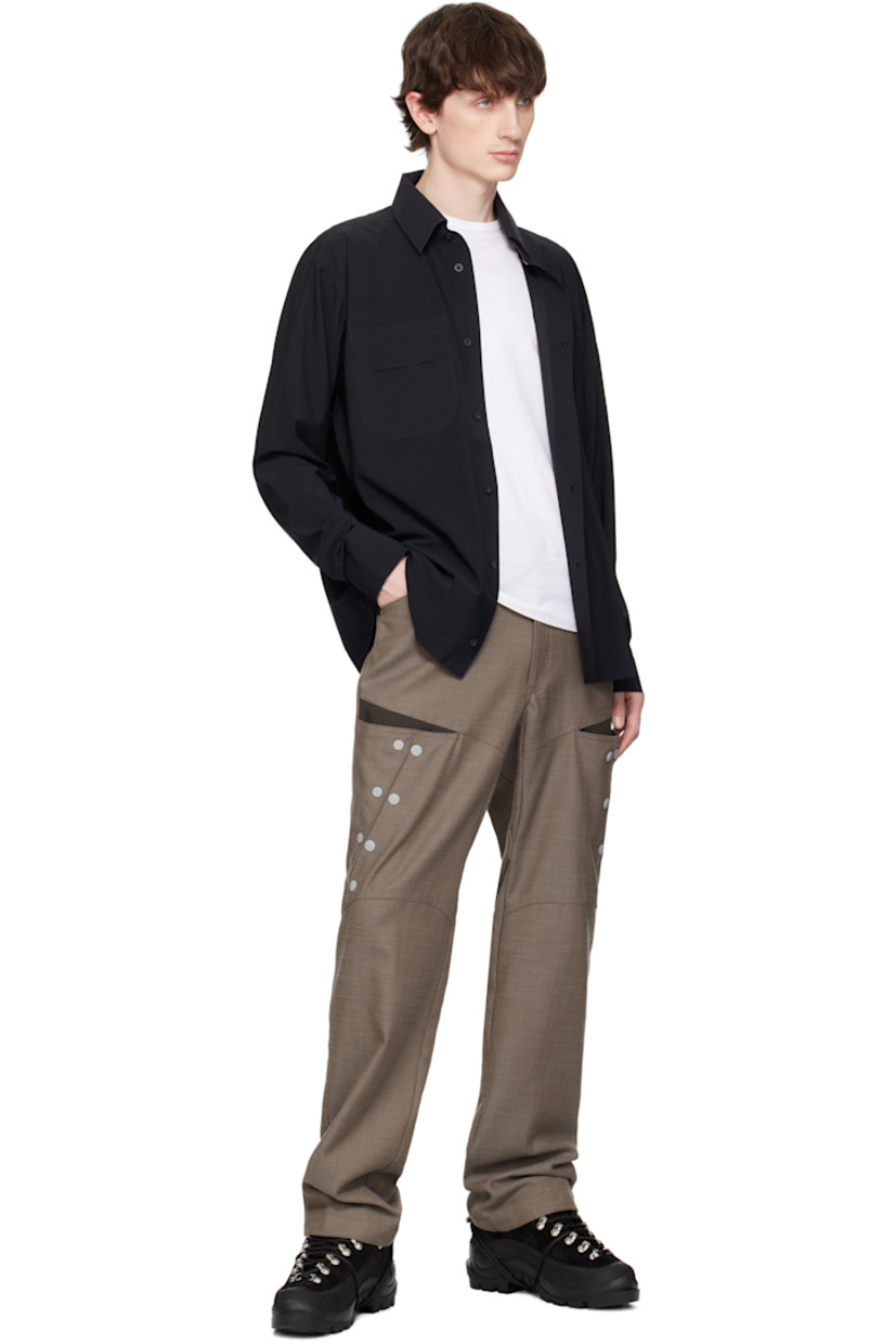 Stretch nylon jersey shirt. Laser-cut raw edges and taped seams throughout.

· Spread collar
· Button closure 
· Flap pockets at chest
· Logo embroidered at shirttail hem
· Barrel cuffs
· Twin pleats at back yoke

Supplier color: Black