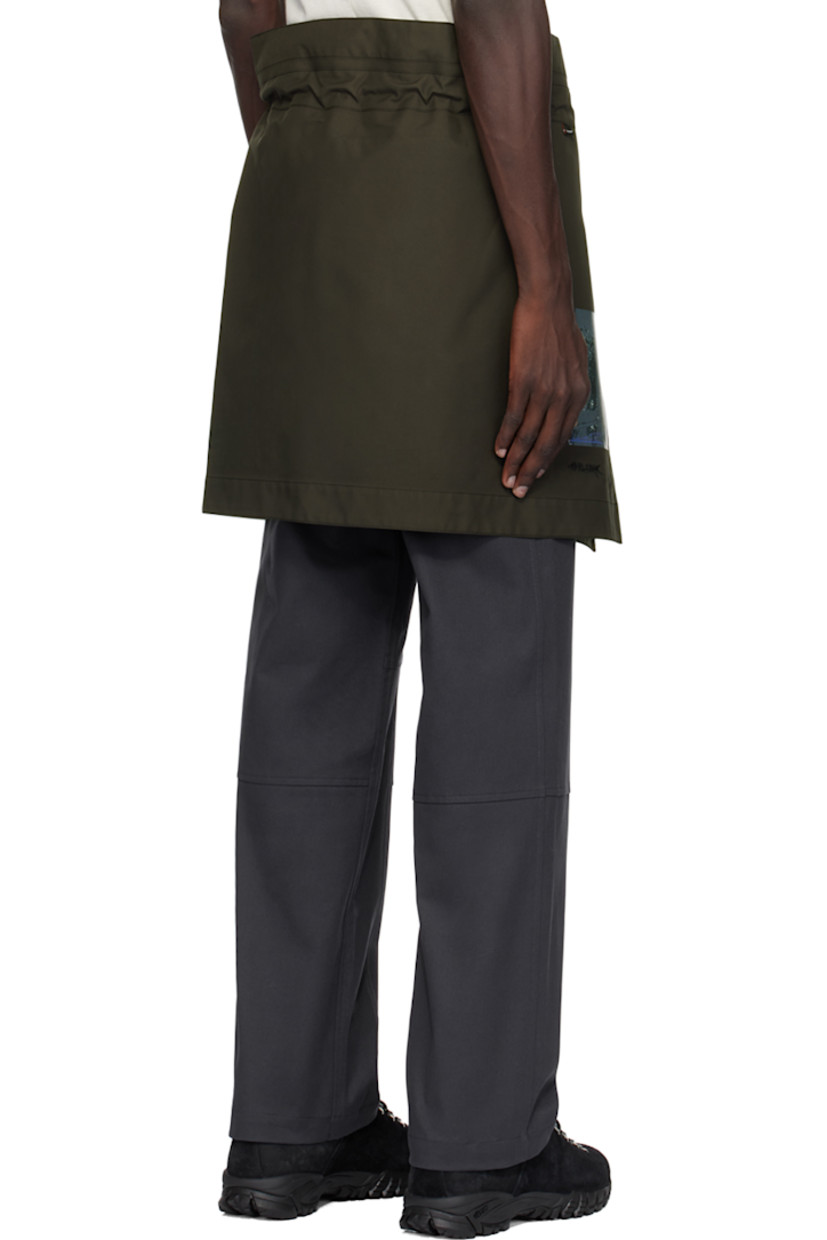 Polyurethane-coated plain-woven Polartec® polyester skirt.

· Wrap construction 
· Drawstring with carabiner at elasticized waistband
· Printed graphic and embroidered logo at front 
· Full fleece lining

Available exclusively at SSENSE.

Supplier color: Dark soil grey